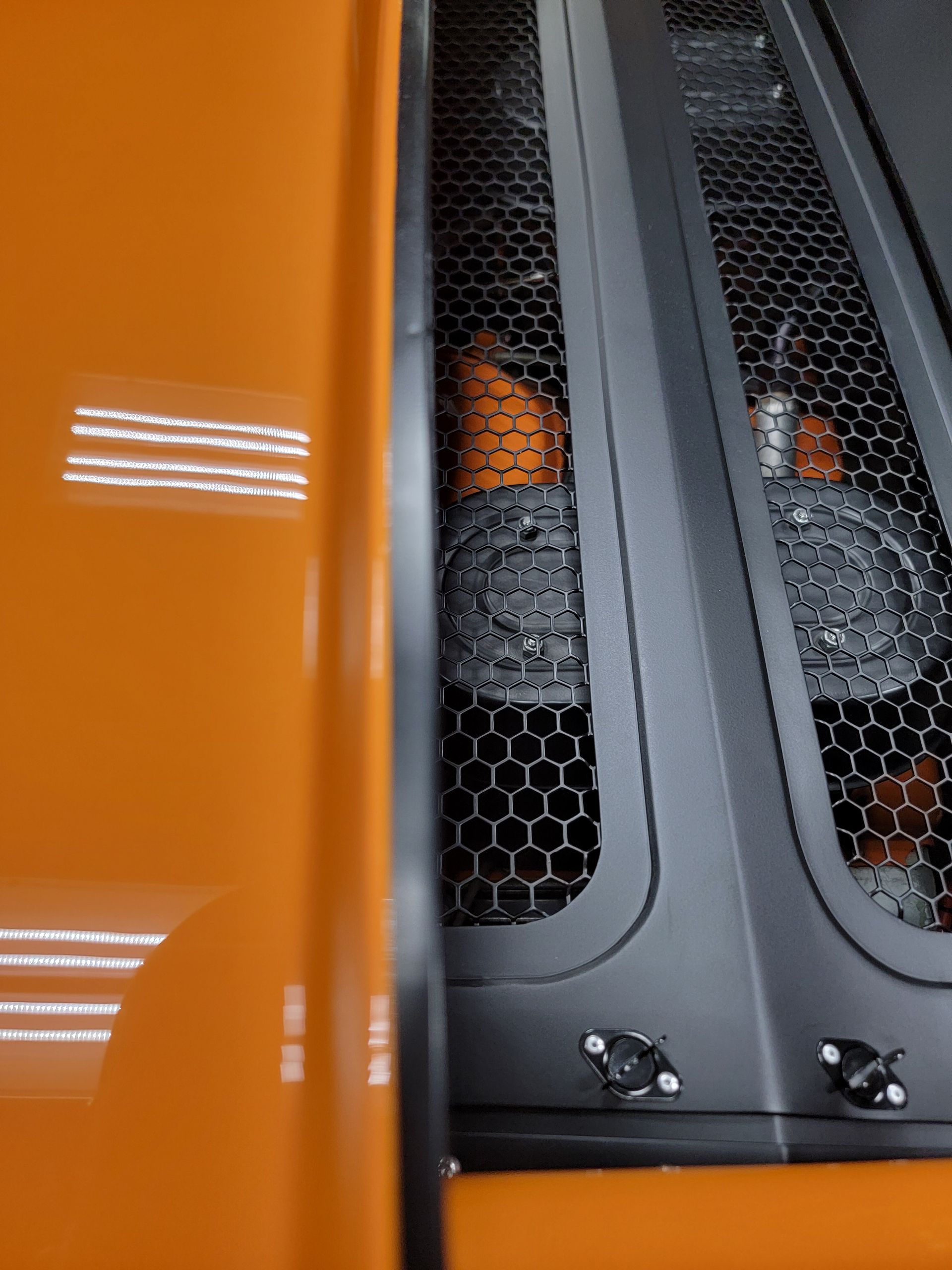 Technician applying a Gtechniq ceramic coating panel by panel inside the Pro Car Care studio
