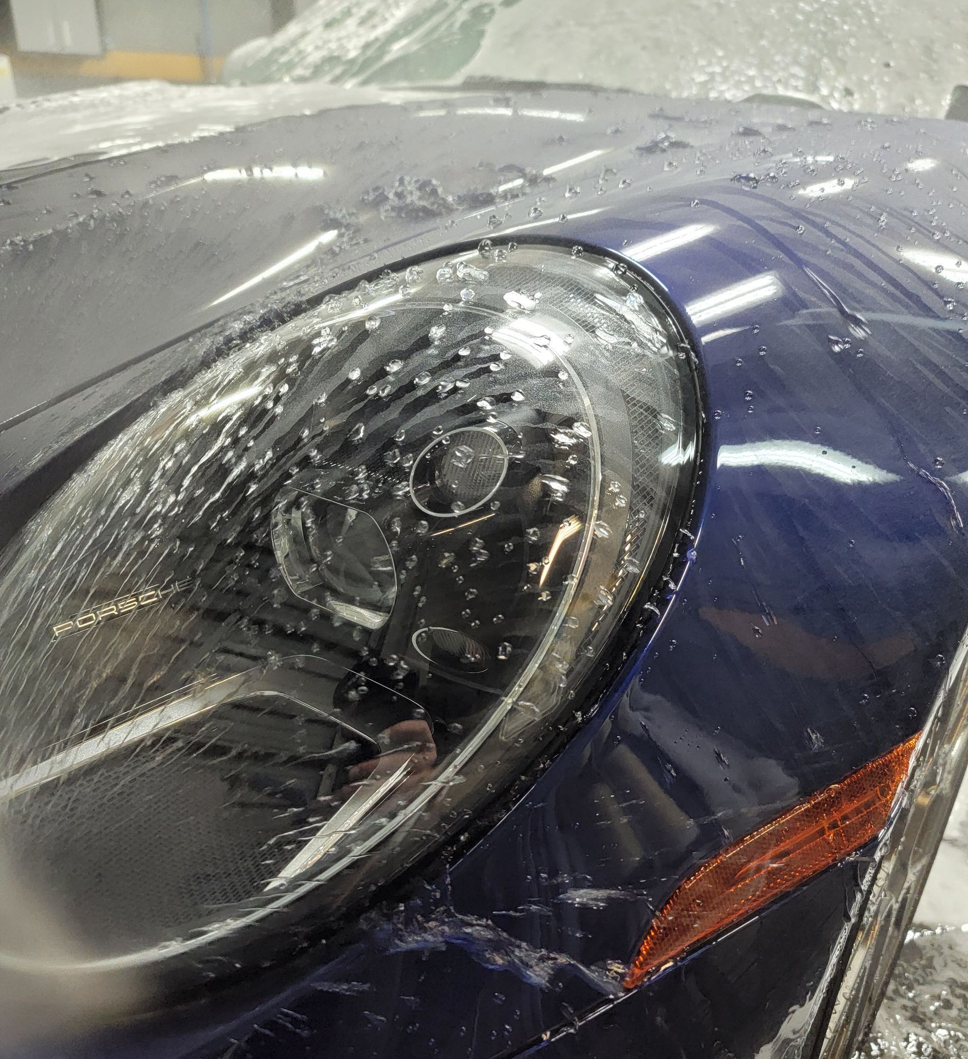 Ceramic-coated Porsche 911 headlight and front fender detail at Pro Car Care